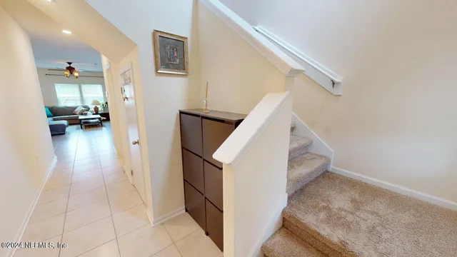a view of a livingroom with furniture and stairs