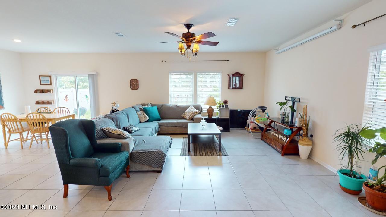 86013 Club Car Place Yulee, FL 32097 - Photo 6 of 28 a living room with furniture potted plant and a window