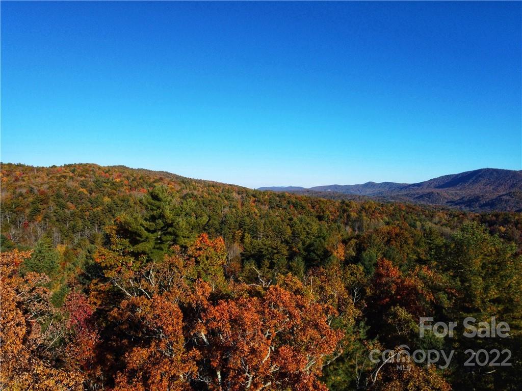 a view of a large building with mountains in the background