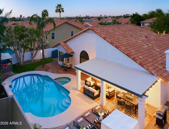 an aerial view of a house with swimming pool and porch