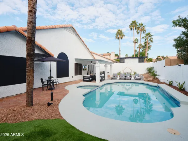 a dining room with furniture and chandelier