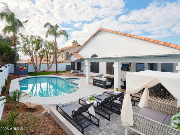 a view of a house with backyard and sitting area