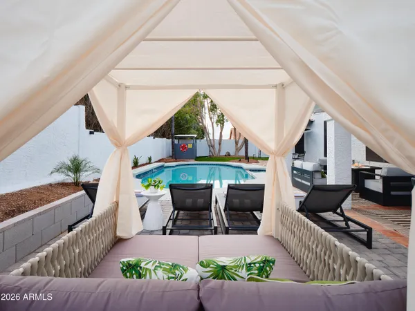 a living room with furniture a fireplace and a potted plant