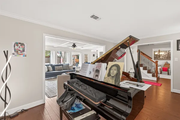 a living room with furniture and a wooden floor