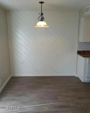 a view of a room with wooden floor and cabinetry