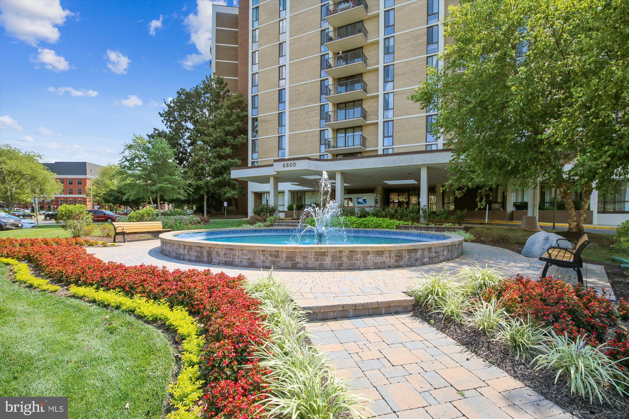 6800 Fleetwood Road, Unit 1004 McLean, VA 22101 - Photo 34 of 40 Charming fountain amidst vibrant landscaping.