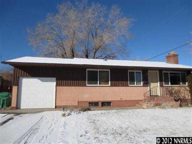675 Lester Avenue Reno, NV 89502 - Photo 1 of 1 a front view of a house with a yard and garage