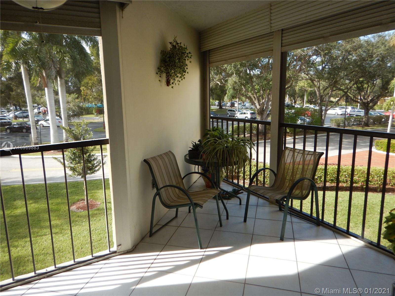 16100 Golf Club Road, Unit 210 Weston, FL 33326 - Photo 11 of 40 a view of a chairs and table in the balcony