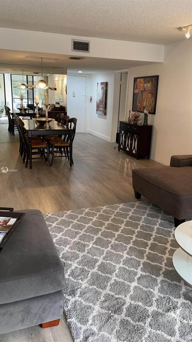 16100 Golf Club Road, Unit 210 Weston, FL 33326 - Photo 12 of 40 a living room filled with furniture