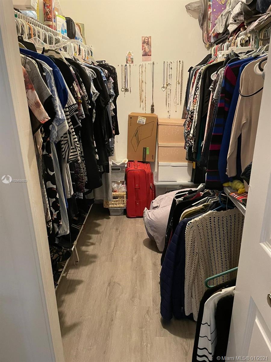 16100 Golf Club Road, Unit 210 Weston, FL 33326 - Photo 19 of 40 a view of walk in closet with clothes and shoes