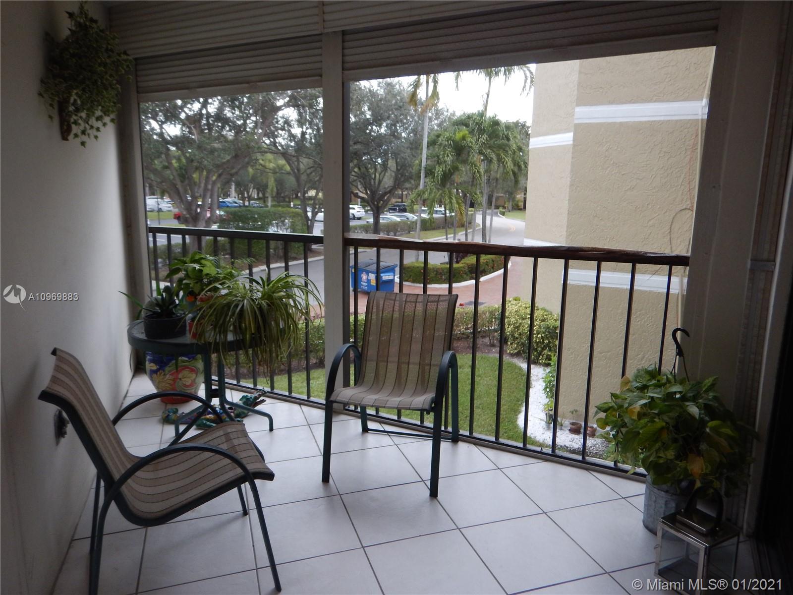 16100 Golf Club Road, Unit 210 Weston, FL 33326 - Photo 30 of 40 a view of a chairs and table in the balcony