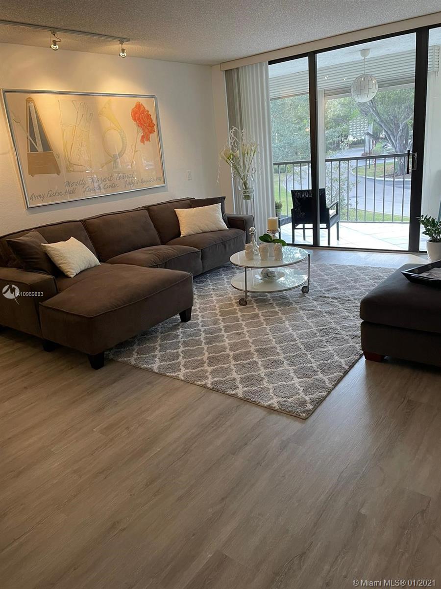 16100 Golf Club Road, Unit 210 Weston, FL 33326 - Photo 4 of 40 a living room with furniture and a large window