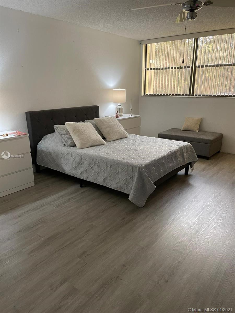 16100 Golf Club Road, Unit 210 Weston, FL 33326 - Photo 36 of 40 a bedroom with bed and window