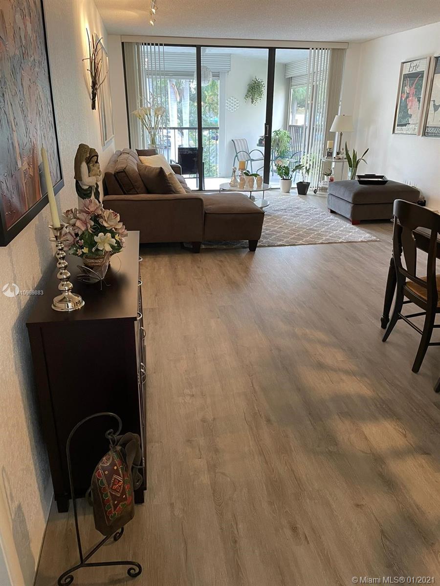 16100 Golf Club Road, Unit 210 Weston, FL 33326 - Photo 37 of 40 a living room with furniture and a large window