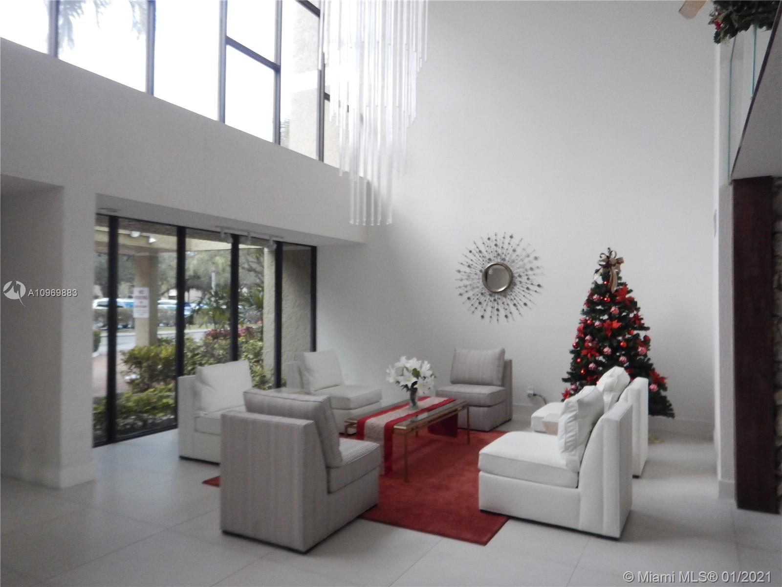 16100 Golf Club Road, Unit 210 Weston, FL 33326 - Photo 38 of 40 a living room with furniture and a large window