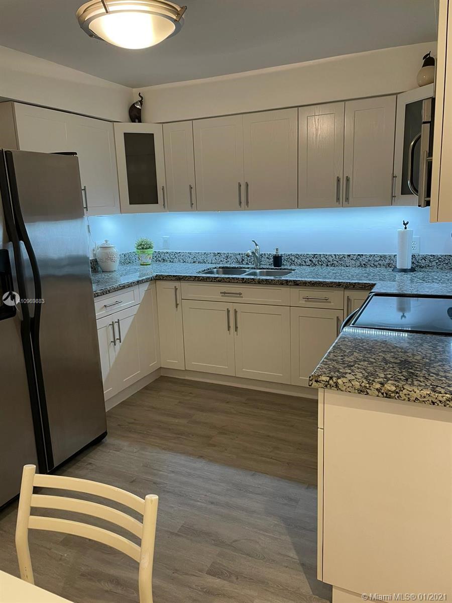 16100 Golf Club Road, Unit 210 Weston, FL 33326 - Photo 6 of 40 a kitchen with granite countertop cabinets and sink