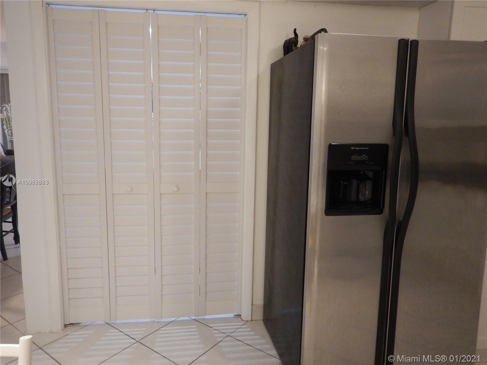 16100 Golf Club Road, Unit 210 Weston, FL 33326 - Photo 7 of 40 a metallic refrigerator freezer sitting in a kitchen