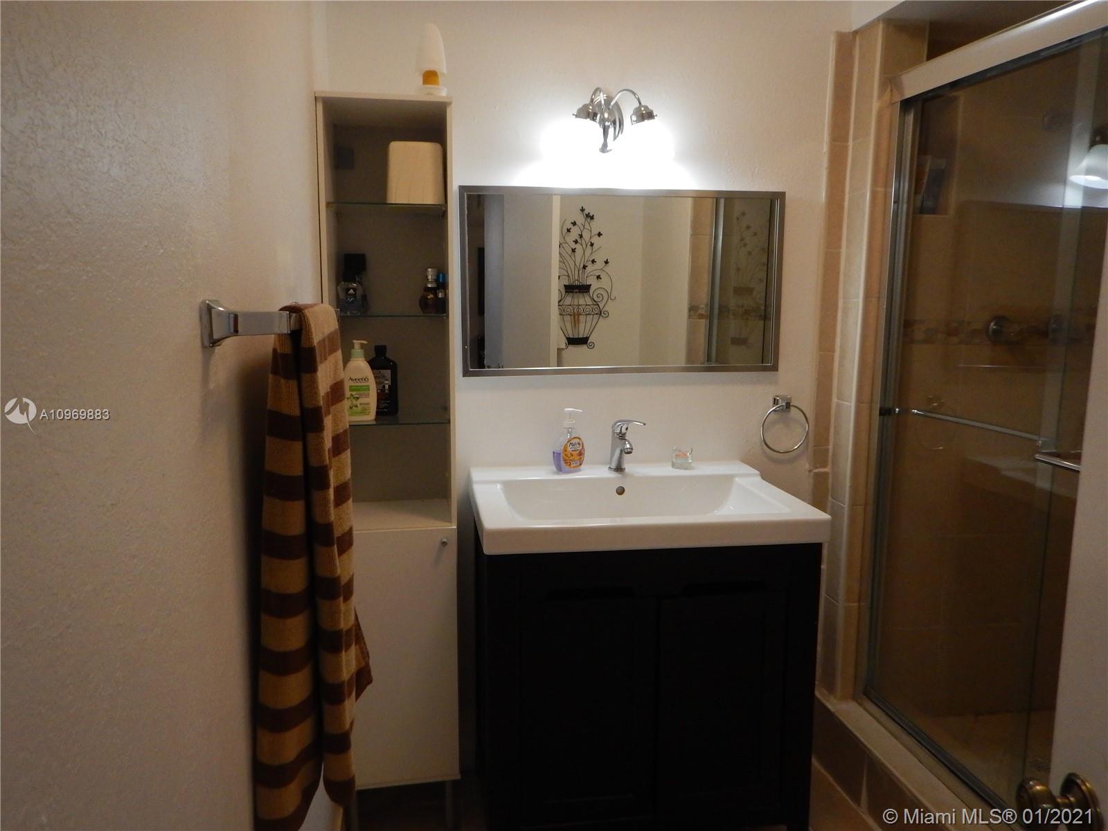 16100 Golf Club Road, Unit 210 Weston, FL 33326 - Photo 10 of 40 a bathroom with a sink and a mirror