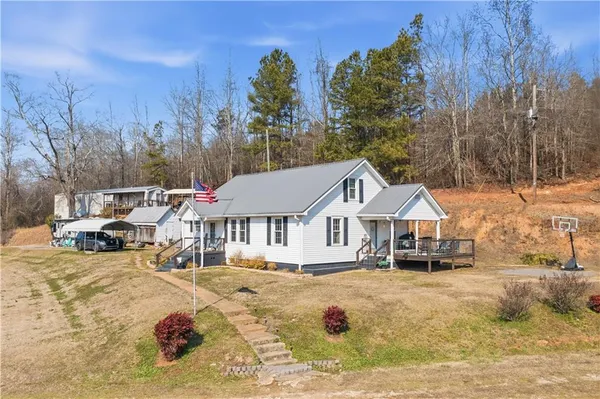 a front view of a house with a yard covered with snow in front of house