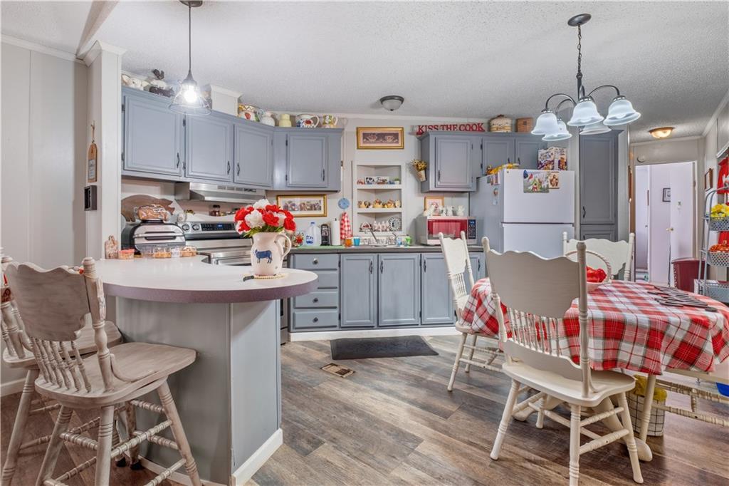 2343 County Road 60 Heflin, AL 36264 - Photo 36 of 46 a kitchen with a dining table cabinets and stainless steel appliances