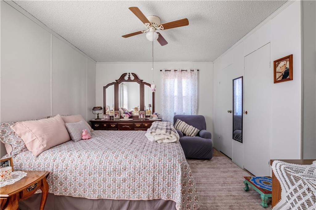 2343 County Road 60 Heflin, AL 36264 - Photo 41 of 46 a bedroom with a bed couch and dresser