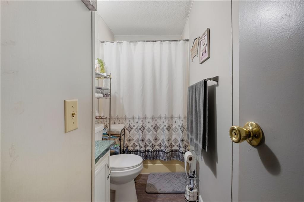2343 County Road 60 Heflin, AL 36264 - Photo 44 of 46 a bathroom with a toilet and shower curtain