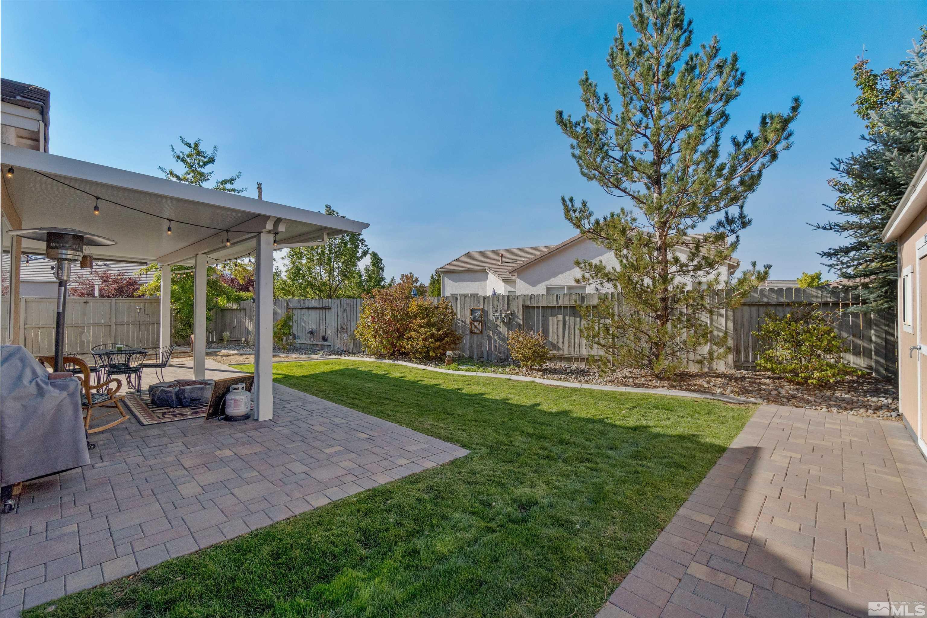 1301 Cranwood Court Reno, NV 89521 - Photo 30 of 34 a view of a patio with a table and chairs under an umbrella