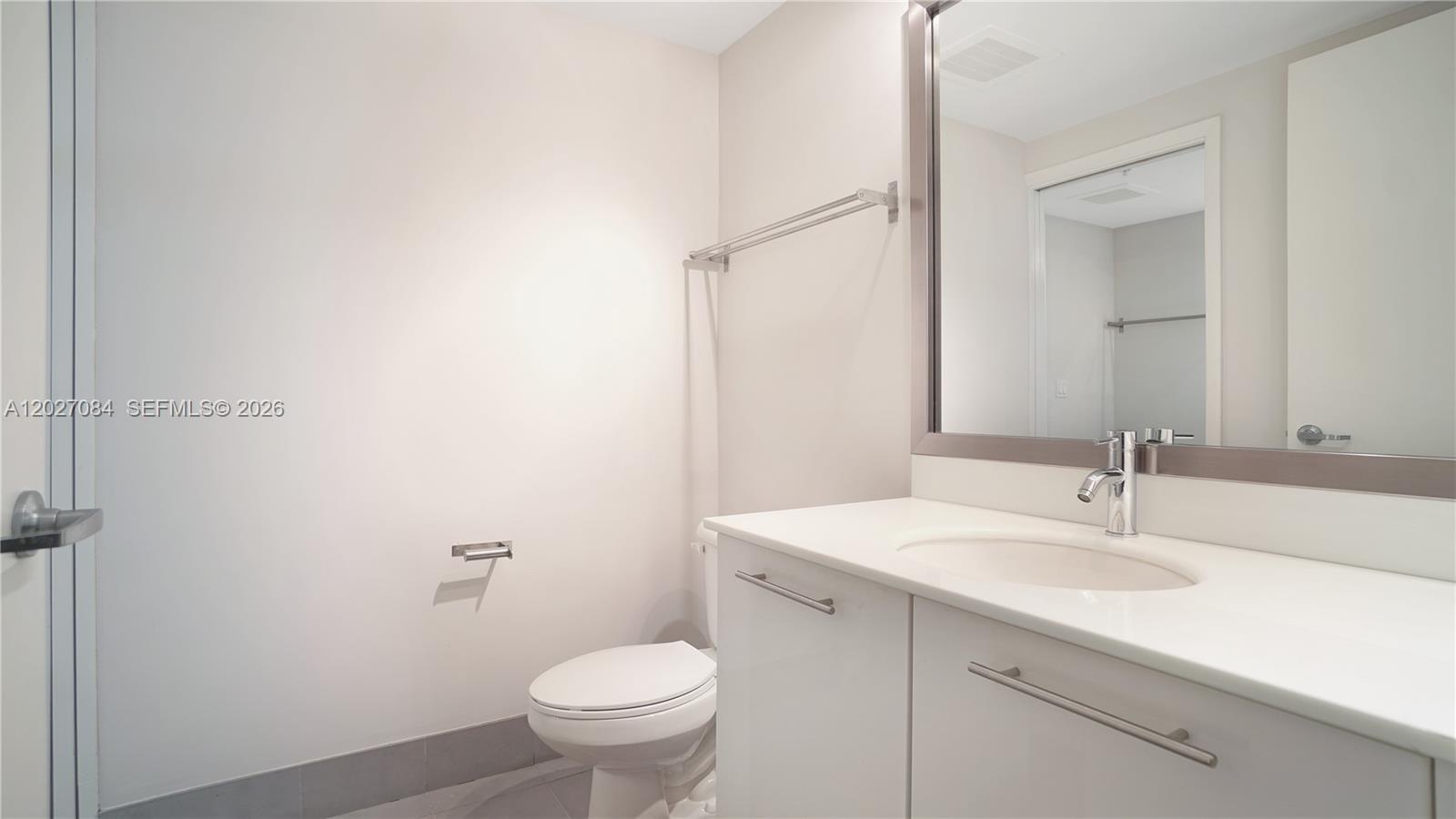 92 Southwest 3rd Street, Unit 1803 Miami, FL 33130 - Photo 15 of 29 a bathroom with a sink toilet and vanity