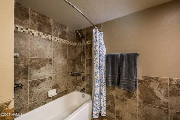 a bathroom with a shower and a tub