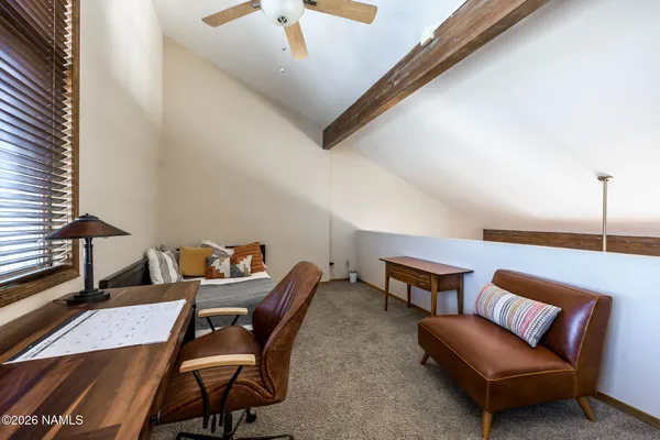 a bedroom with furniture and a window
