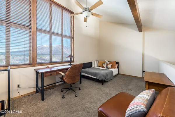 a bedroom with a bed and windows