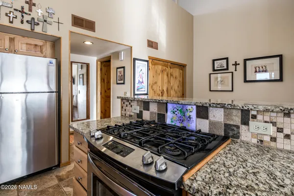 a kitchen with stainless steel appliances granite countertop a stove and a refrigerator