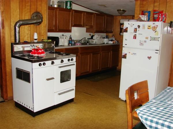 688 New Sherborn Road Athol, MA 01331 - Photo 3 of 14 a white kitchen with wooden cabinets and white appliances