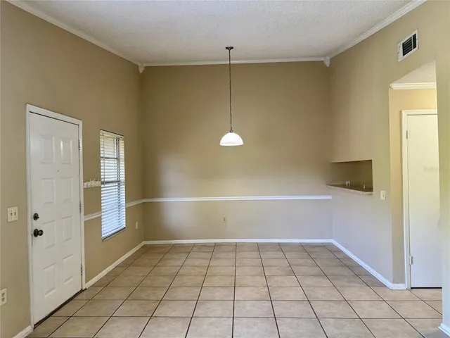 a view of a room with window and brick walls
