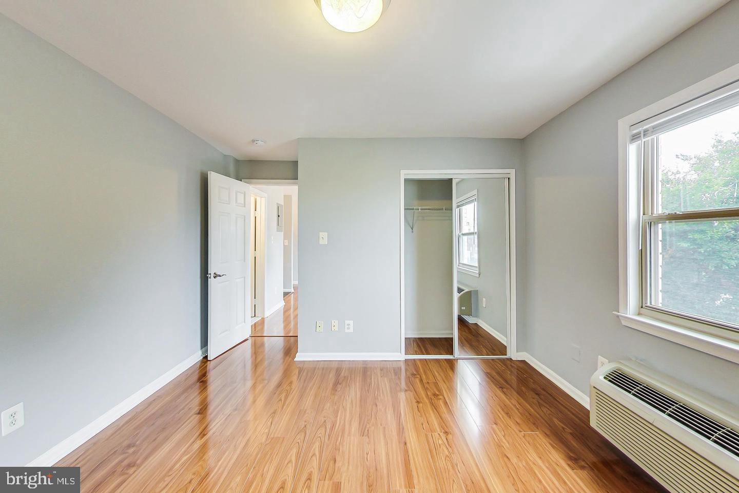 604 Longfellow Street Northwest, Unit 303 Washington, DC 20011 - Photo 11 of 12 a view of an empty room with wooden floor and a window