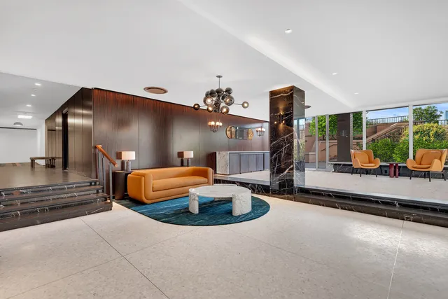 a living room with furniture a garden and a large window