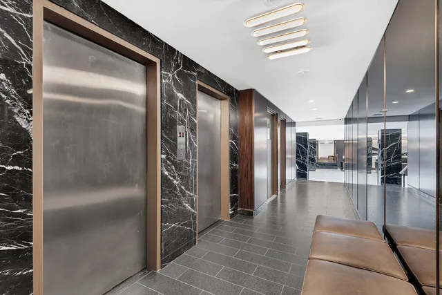 a hallway with dining area and chandelier