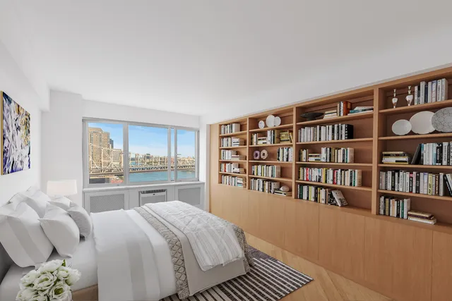 a spacious bedroom with a bed and a book shelf