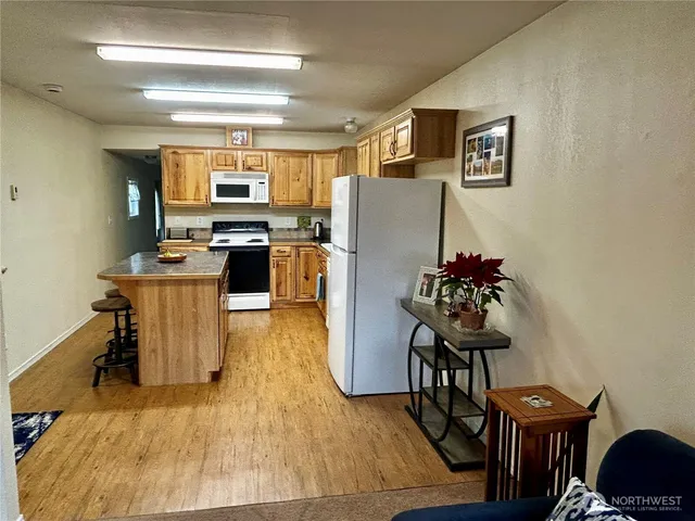 a room with furniture a chandelier and a flat screen tv