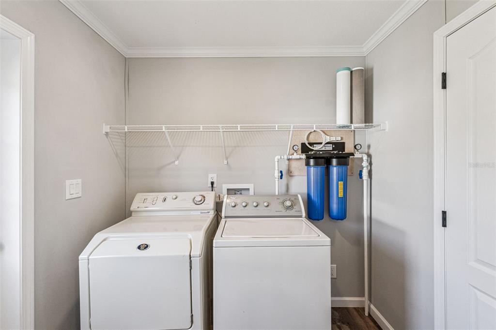 180 Sandpine Court St. Cloud, FL 34771 - Photo 25 of 28 a utility room with dryer and washer