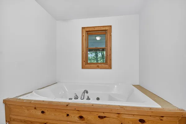 a bathroom with a window and sink
