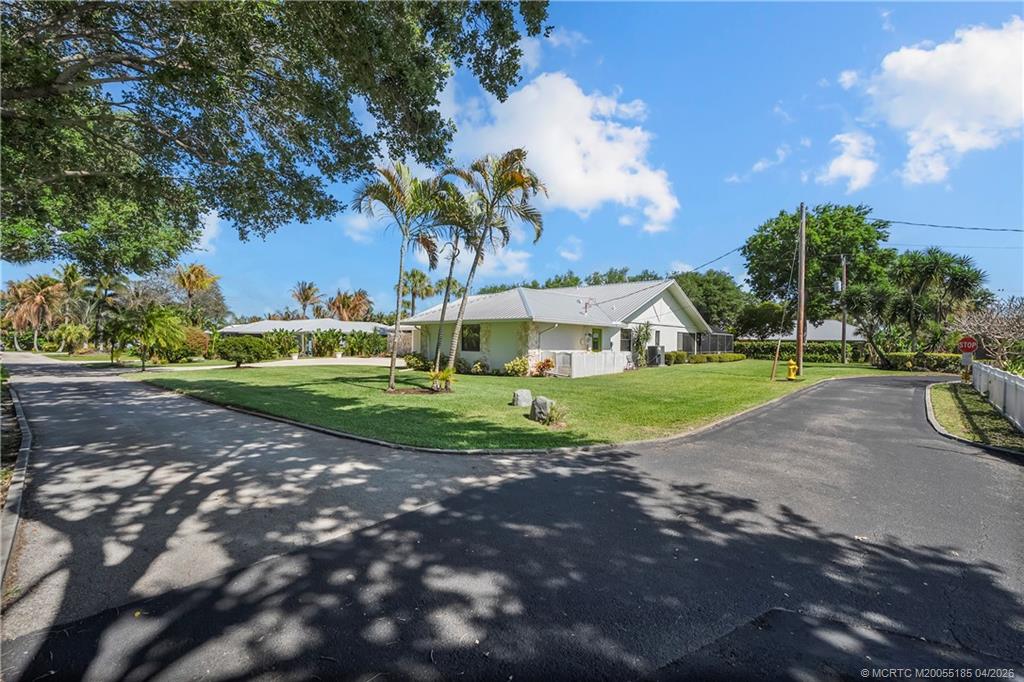 4620 Southeast Quail Trail Stuart, FL 34997 - Photo 40 of 71 a view of a house with a big yard