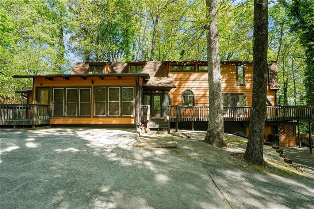 a view of a house with a large window and a tree