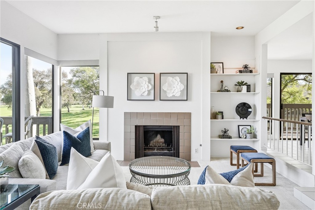 10 Lago Norte Irvine, CA 92612 - Photo 1 of 29 a living room with furniture a fireplace and a large window