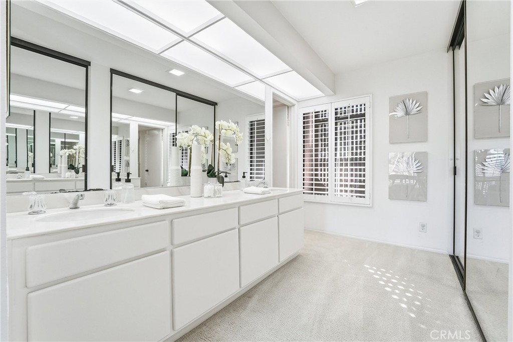 10 Lago Norte Irvine, CA 92612 - Photo 14 of 29 a spacious bathroom with double vanity and a large mirror