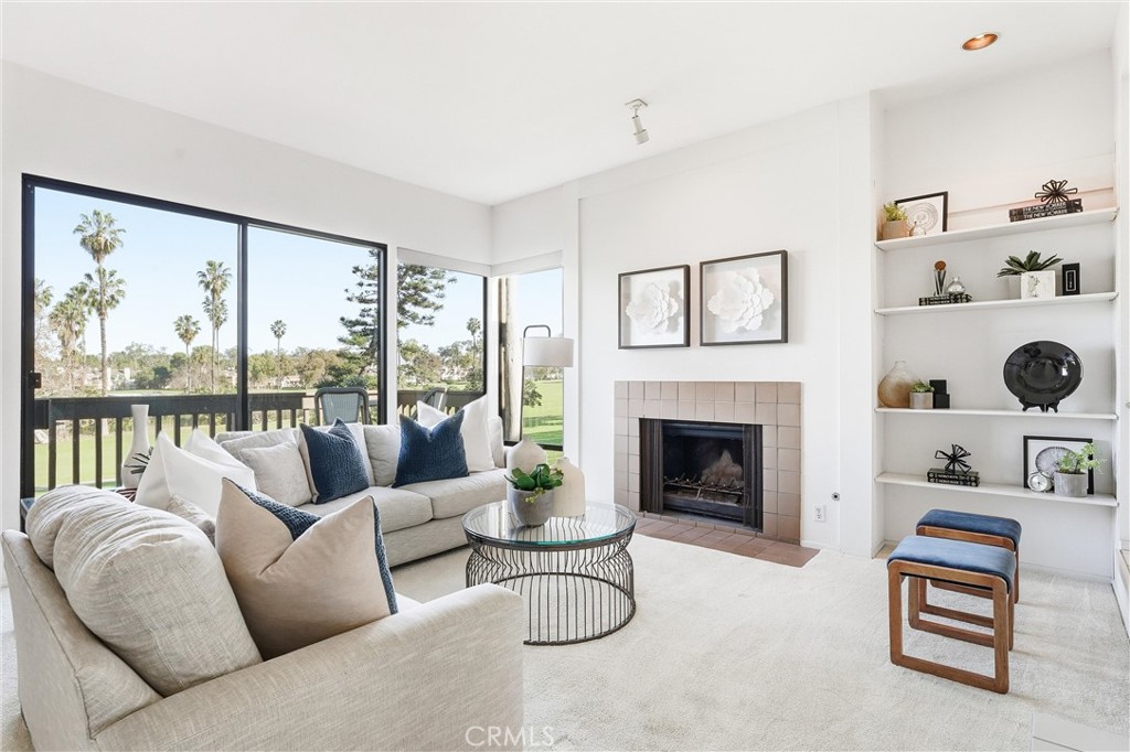 10 Lago Norte Irvine, CA 92612 - Photo 2 of 29 a living room with furniture a fireplace and a large window