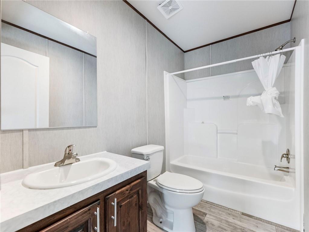 222 Lynn Road Bethlehem, GA 30620 - Photo 24 of 45 a bathroom with a sink a toilet and a bathtub