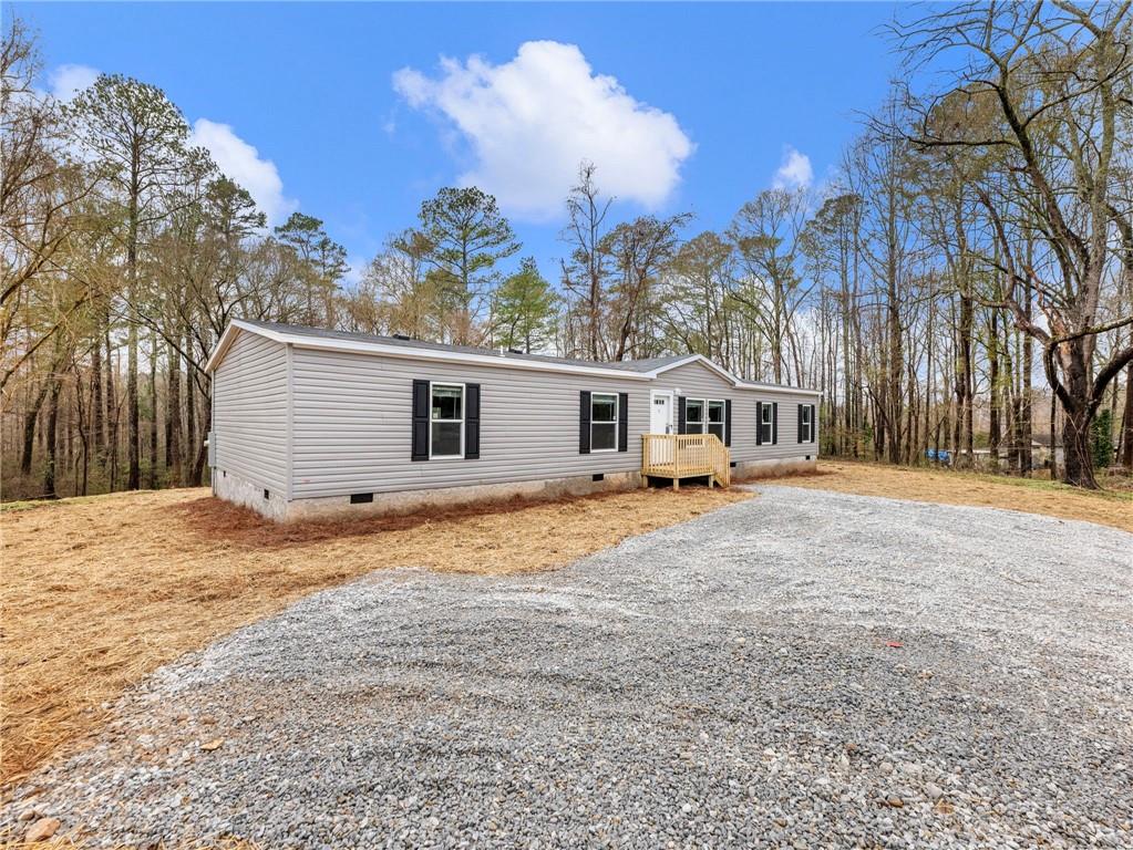 222 Lynn Road Bethlehem, GA 30620 - Photo 31 of 45 a house with trees in front of it
