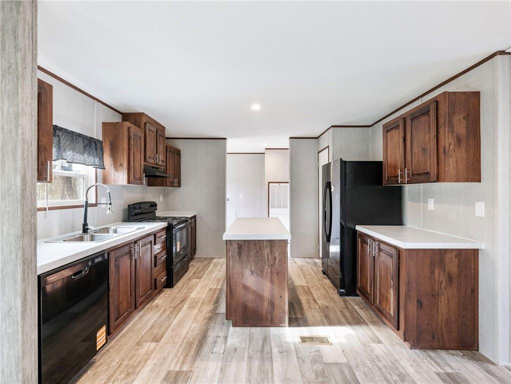 222 Lynn Road Bethlehem, GA 30620 - Photo 6 of 45 a kitchen with stainless steel appliances a sink cabinets and wooden floor