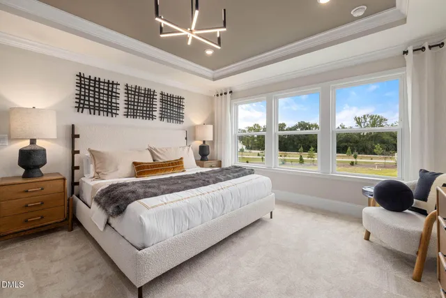 a living room with furniture a flat screen tv and a large window